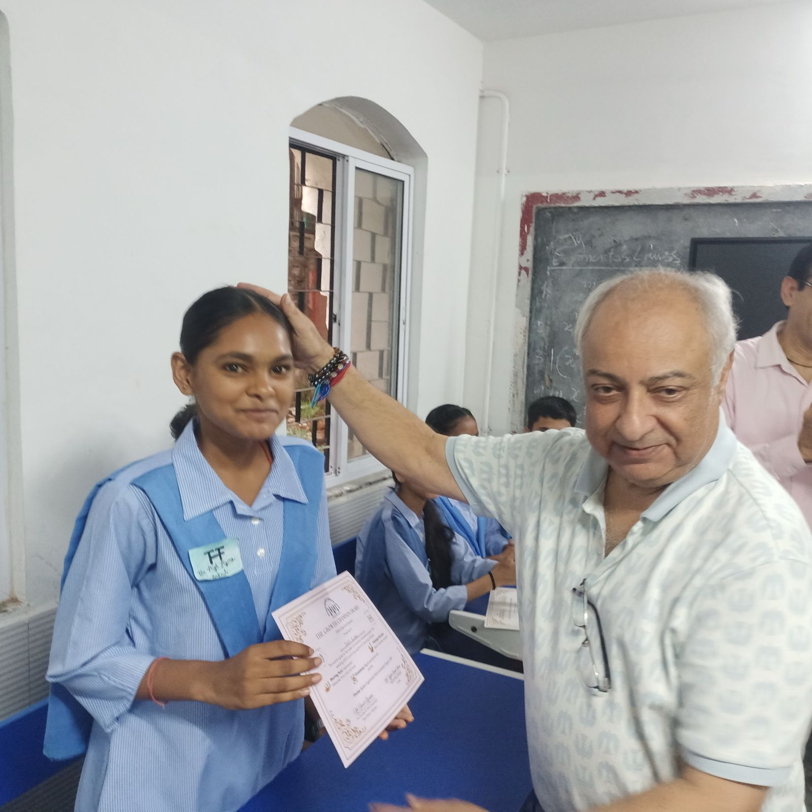 Students holding certificates after completing a program activity